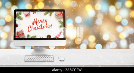 Merry Christmas greeting on computer display on white wooden desk. Bokeh and Christmas lights in background. Copy space beside. Keyboard and mouse on Stock Photo