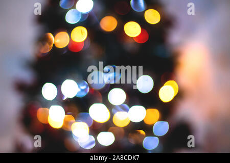 Abstract blurred background of blue and silver glittering shine bulbs lights garland. Christmas wallpaper decorations concept. Xmas holiday background Stock Photo