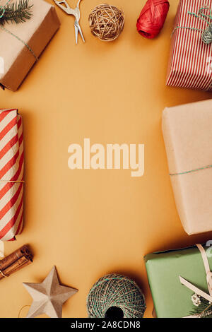 Frame from Christmas presents and other decoration on yellow background Stock Photo