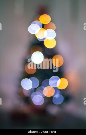 Abstract blurred background of blue and silver glittering shine bulbs lights garland. Christmas wallpaper decorations concept. Xmas holiday background Stock Photo