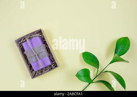 Goat milk soap on a yellow background. Organic cosmetics. Flat lay. Minimalistic composition. Stock Photo