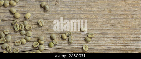 Coffee beans green color unroasted on wood background, banner, copy space Stock Photo