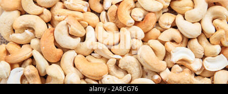 Cashew nuts peeled raw full background texture, banner, top view, Stock Photo