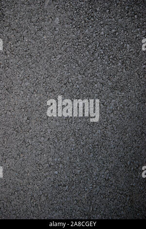 Smooth, dark, new asphalt in a full frame close-up background Stock Photo