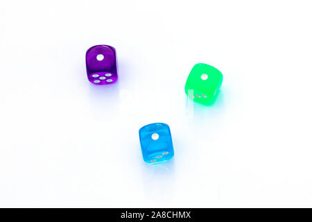 three multi-colored dice with the number one on the sides on white background Stock Photo