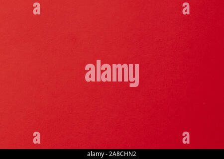 Clean red paper texture with a simple surface. High resolution photo. Color paper, flame red paper. Empty bright red paper backgrounds. Stock Photo