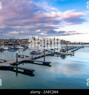 Late evening at Ramsgate harbour. With fishing boats, yachts, little boats and speed boats. Deep blue skies and reflections on the sea. Stock Photo