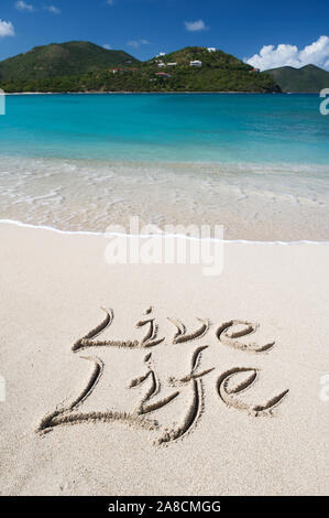Inspirational message Live Life handwritten in smooth sand on a tropical beach Stock Photo