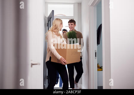 Group Of College Student Carrying Boxes Moving Into Accommodation Together Stock Photo