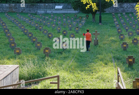 Woman visiting the Austro-Hungarian military cemetery of Prosecco-Prosek, on the Karst plateau next to Trieste Stock Photo