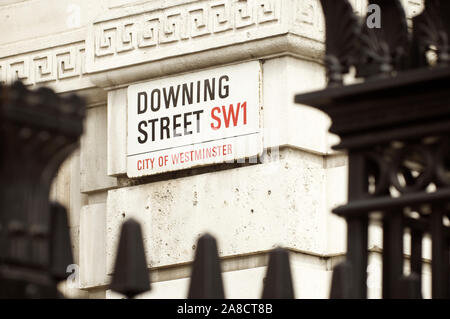 LONDON - JUNE 2011: A road sign for Downing Street, where the residence of the Prime Minister is located, on a Westminster building. Stock Photo
