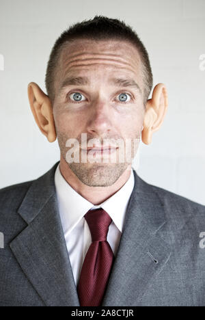 Portrait of businessman with large ears looking at the camera with a curious expression Stock Photo