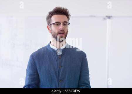 Portrait of male teacher at work. Male professor explain to students. Stock Photo