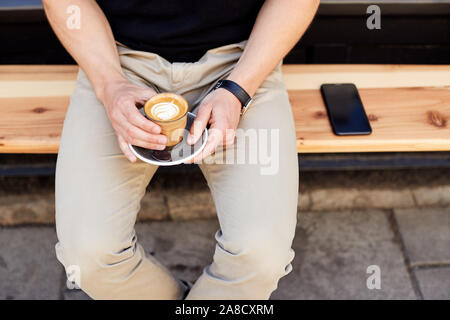 Close Up Of Man Sitting Outside Coffee Shop Drinking Coffee Stock Photo