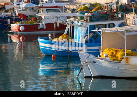 Heraklion, Crete, Greece. Fishing boats reflected in the tranquil waters of the Venetian Harbour. Stock Photo