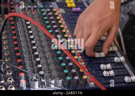 DJ hand on a mixer, operating the leader Stock Photo