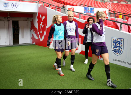 (left to right) England's Rachel Daly, Millie Bright and Liam Williamson during the training session at Wembley Stadium, London. Stock Photo