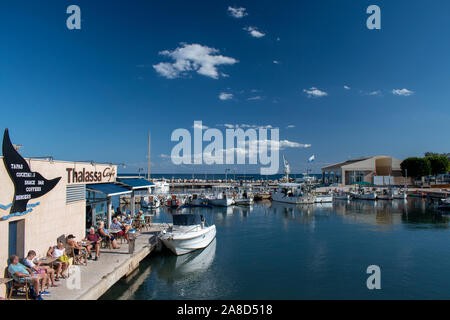 Cala Bona, Majorca ,Spain, October 15, 2019, Thalassa Cafe holidaymakers enjoying the beautiful view of Cala Bona Marina. Stock Photo