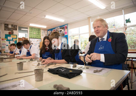 Prime Minister Boris Johnson tries his hand at making an Antony Gormley inspired clay figure during an arts class whilst visiting the George Spencer Academy in Nottingham, while on the General Election campaign trail around the country. Stock Photo