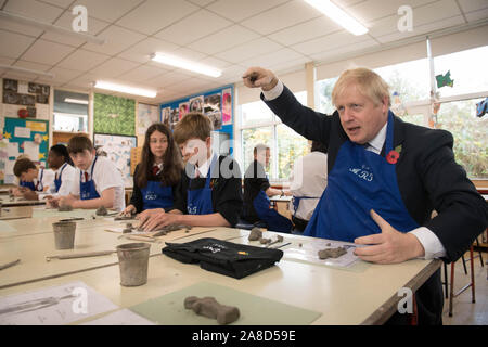 Prime Minister Boris Johnson tries his hand at making an Antony Gormley inspired clay figure during an arts class whilst visiting the George Spencer Academy in Nottingham, while on the General Election campaign trail around the country. Stock Photo