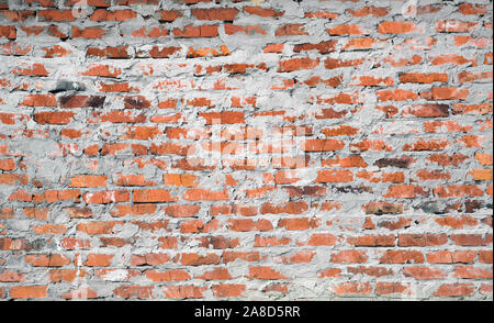 Red brick wall with rough cement mortar. Background. Stock Photo