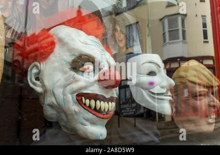 Close up of mask masks in window of The Joke Shop store Scarborough North Yorkshire England UK United Kingdom GB Great Britain Stock Photo