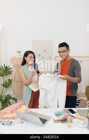 Partners during work. Two fashion designers discussing new design at the studio Stock Photo