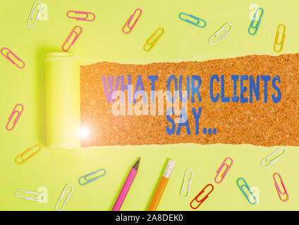 Word writing text What Our Clients Say. Business photo showcasing your customer feedback using poll or written paper Stationary and torn cardboard pla Stock Photo