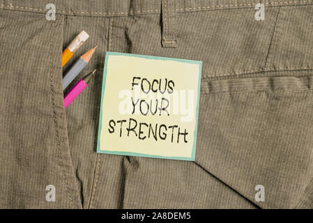 Text sign showing Focus Your Strength. Business photo showcasing Improve skills work on weakness points think more Writing equipment and green note pa Stock Photo