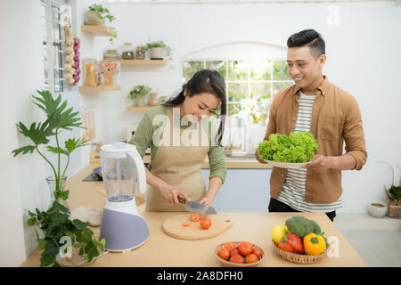 Attractive couple is cooking on kitchen. Stock Photo