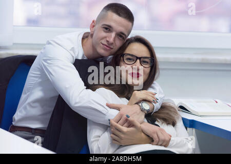Loving life on campus. Young couple on campus during class in classroom. Stock Photo