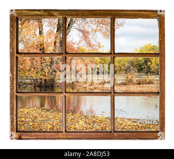 flooded Missouri River in fall colors scenery as seen from a vintage sash window Stock Photo