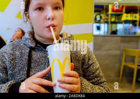 NewYork NY NOV 07 2019: Little girl drinking Mcdonald's cup at drink soda sold Stock Photo