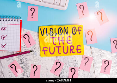 Writing note showing Vision Of The Future. Business concept for Seeing something Ahead a Clear Guide of Action Writing tools and scribbled paper on to Stock Photo