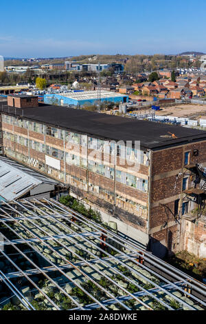 Aerial, overhead views of an abandoned factory, left to decline in the poor city of Hanley, Stoke on Trent, located right next to a busy motorway Stock Photo