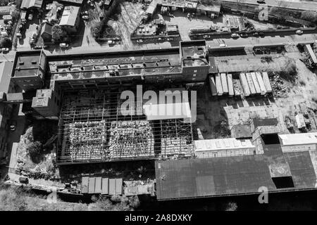 Aerial, overhead views of an abandoned factory, left to decline in the poor city of Hanley, Stoke on Trent, located right next to a busy motorway Stock Photo