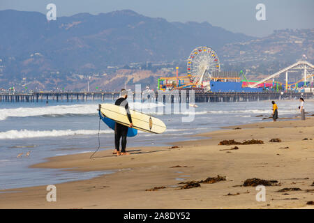Surfers on the shore at Santa Monica beach. , Los Angeles County, California, United States of America Stock Photo