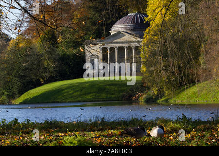 The stone pavilion at Stourhead. A wonderful folly in the Georgian landscaped gardens . The lake in front and the woods behind. Autumn and sunny. 2 Stock Photo