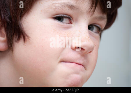 Close up of a young boy looking to get into trouble. Stock Photo