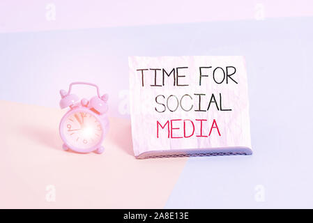 Conceptual hand writing showing Time For Social Media. Concept meaning meeting new friends discussing topics news and movies Alarm clock beside a Pape Stock Photo