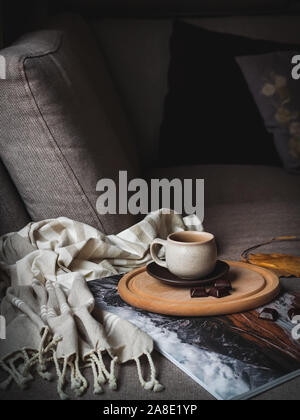 Morning coffee with chocolate on a couch. Cozy weekend moment Stock Photo