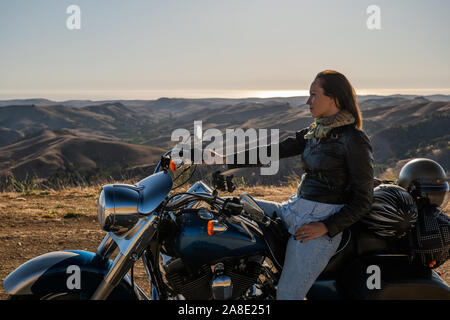 Woman biker sitting on her motorcycle. Stock Photo