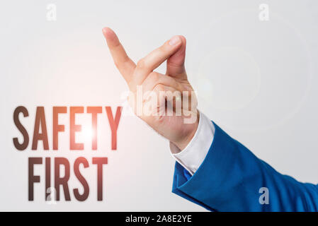 Handwriting text Safety First. Conceptual photo used to say that the most important thing is to be safe Isolated hand pointing with finger. Business c Stock Photo