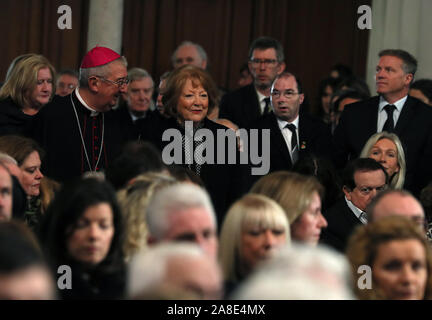 Kathleen Watkins, wife of the celebrated broadcaster Gay Byrne, is escorted by Archbishop Diarmuid Martin into St. Mary's Pro-Cathedral in Dublin for his funeral service. Stock Photo