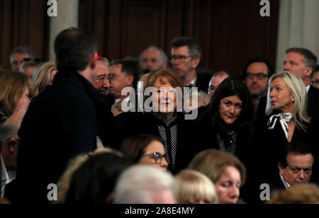 Kathleen Watkins, wife of the celebrated broadcaster Gay Byrne, is escorted by Archbishop Diarmuid Martin into St. Mary's Pro-Cathedral in Dublin for his funeral service. Stock Photo