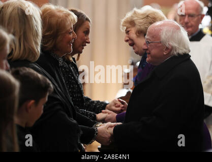 President Michael D. Higgins greets Kathleen Watkins (left), wife of the celebrated broadcaster Gay Byrne, in St. Mary's Pro-Cathedral in Dublin during his funeral service. Stock Photo