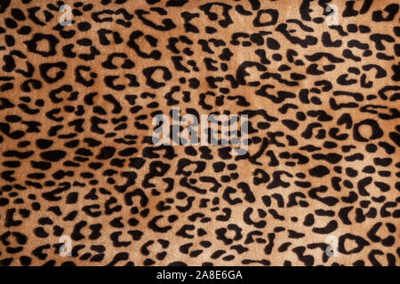 Faux fur leopard texture background. Fashionable modern ecological material. Plaid or carpet. Stock Photo