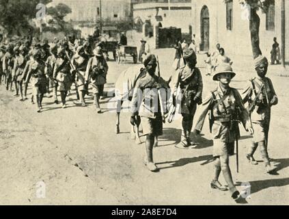 Indian soldiers and British officer, First World War, 1914-1918, (c1920). 'The Road to the Front: Indian troops on the march'. From &quot;The Great World War: A History&quot;, Volume V, edited by Frank A Mumby. [The Gresham Publishing Company Ltd, London, c1920] Stock Photo