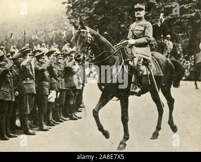 Marshal Foch at the Victory Day Procession, London, 19 July 1919, (c1920). 'A Salute from the Guards: Marshal Foch, baton in hand, riding at the head of the French troops...'. Marshal Ferdinand Foch (1851-1929), supreme commander of the Allied Armies, takes part in the Peace Day celebrations to mark the end of the First World War. From &quot;The Great World War: A History&quot;, Volume IX, edited by Frank A Mumby. [The Gresham Publishing Company Ltd, London, c1920] Stock Photo
