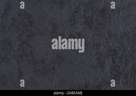 Black paper with abstract texture for background. Paper for interior and exterior decoration or background for handcrafts. Black paper background. Stock Photo